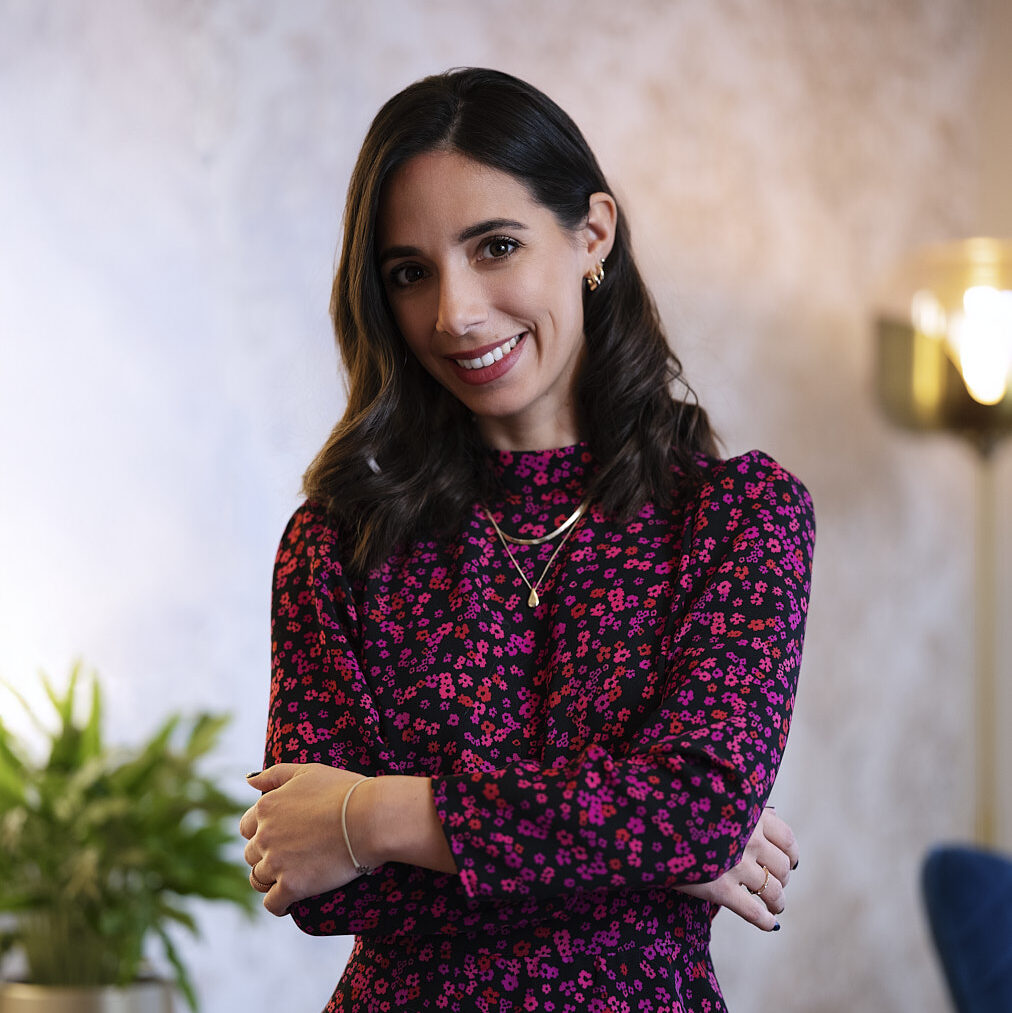 woman, smiling, red dress, office area